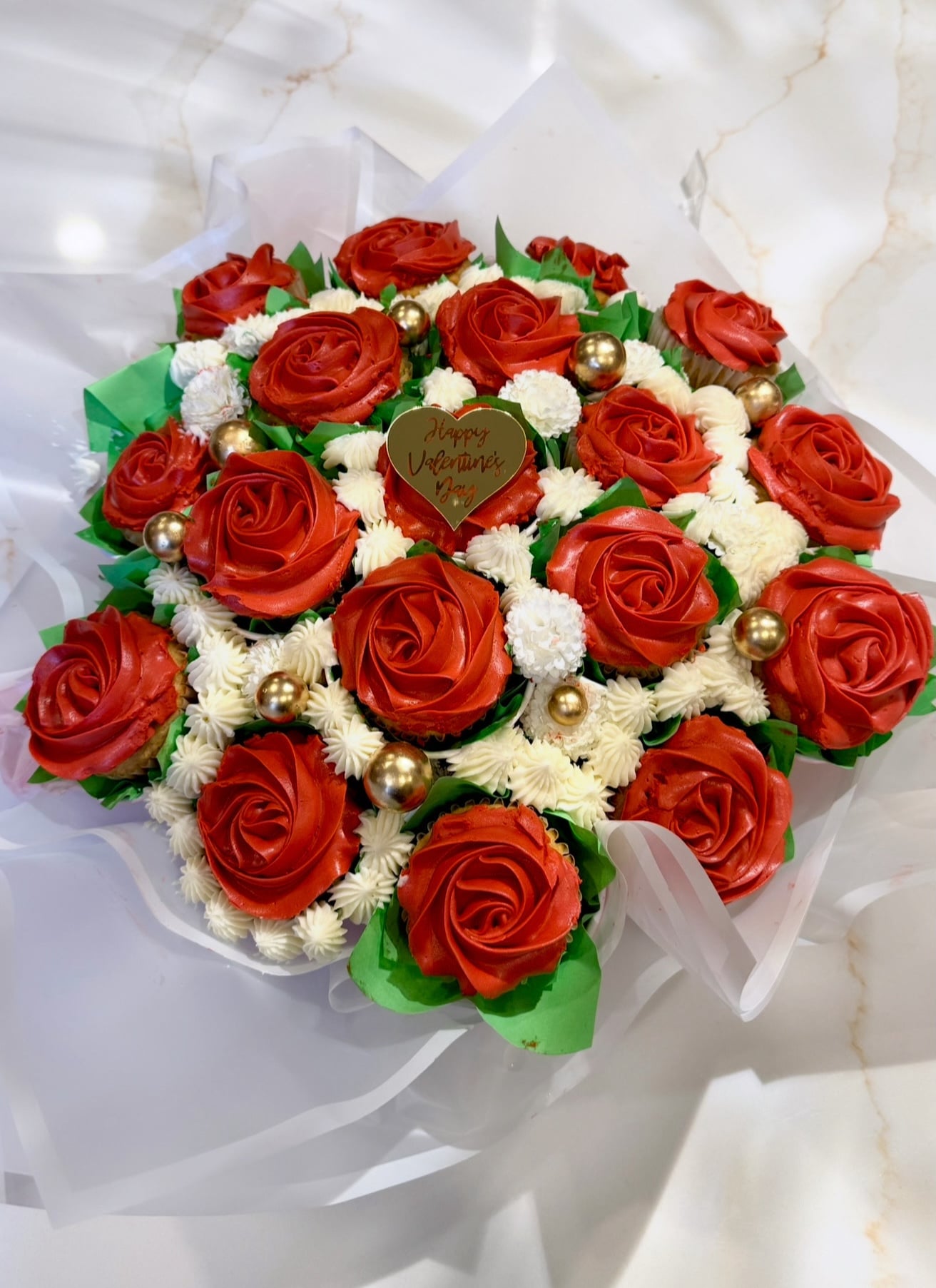 Romantic Valentine's Day cupcake bouquet with pink and red frosted treats, handcrafted by Cakes by Ashni in New Jersey